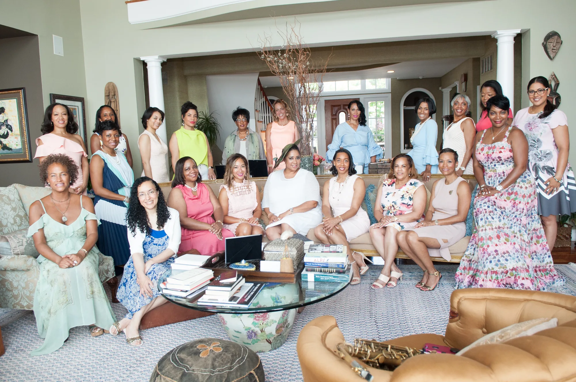 A group of women gathered in an elegant living room for a private retreat.